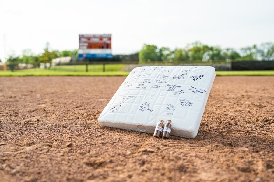 photo of a baseball base with signatures on it